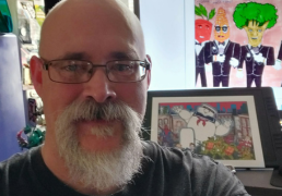 Shawn and examples of his art and toy collection.