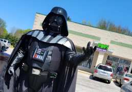 Greg cosplaying as Darth Vader seemingly holds The POP! Shop in his Force grip.